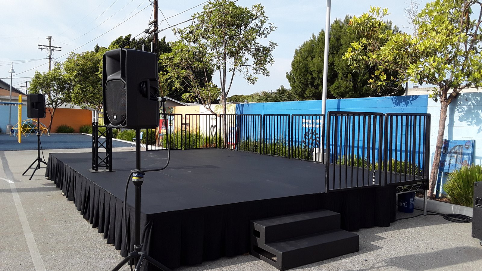 24' W x 16' D x 2' H Steeldeck portable stage rental with safety railing for Southern California events